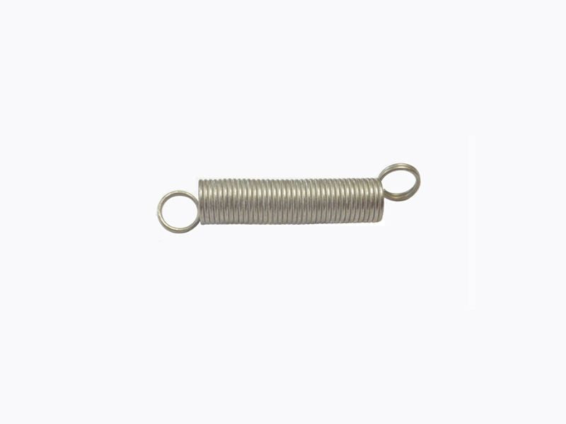 Spring for slide cover ignition switch